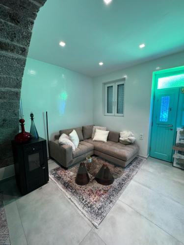 a living room with a couch and a blue ceiling at Villa Benjamin in Milatos