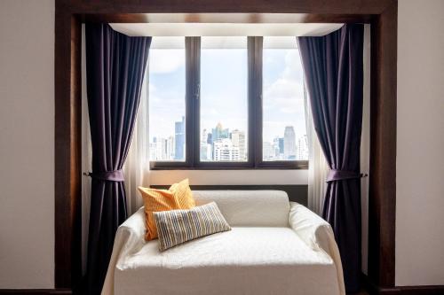 En eller flere senge i et værelse på Artichoke Suite Sukhumvit, Nana BTS