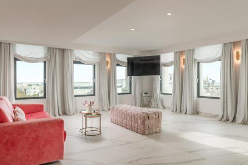 a living room with a red couch and a table at 45 Times Barcelona Hotel in Barcelona