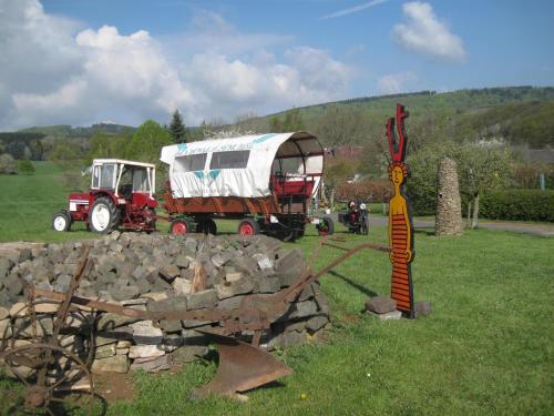 a truck with a camper hooked up to a pile of rocks at Landhaus Müller am Nationalpark Hunsrück-Hochwald in Schwollen