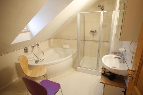 a attic bathroom with a shower and a sink at Landhaus Müller am Nationalpark Hunsrück-Hochwald in Schwollen