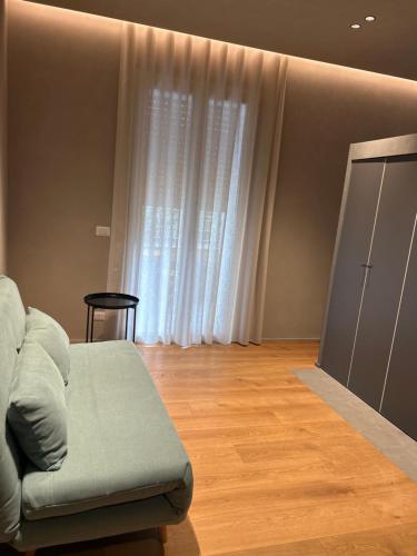 a living room with a couch and a window at Berht - Appartamenti al centro di Catania in Catania