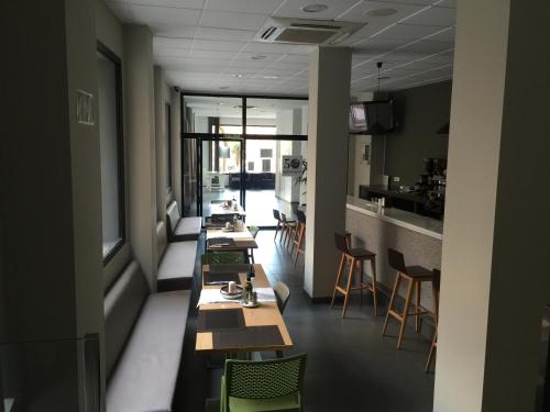 a row of tables in a room with chairs at La Perla in Almería
