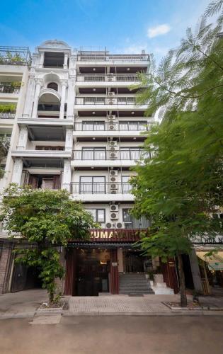 a large white building with trees in front of it at Azumaya Kim Mã 3 in Hanoi