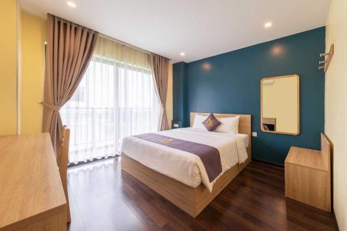 a bedroom with a large bed and a mirror at Azumaya Kim Mã 3 in Hanoi
