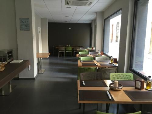 a classroom with tables and chairs and a chalkboard at La Perla in Almería