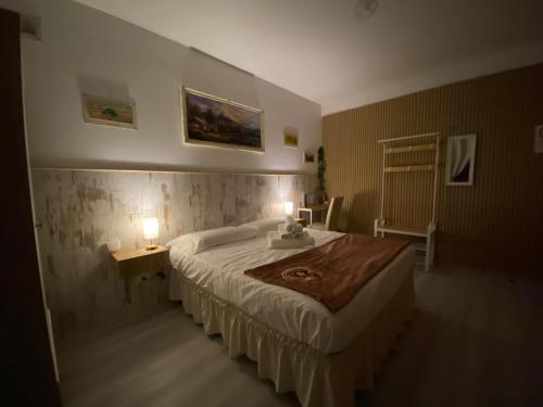 a bedroom with a large bed with two lights on it at Perugia Suite in Perugia
