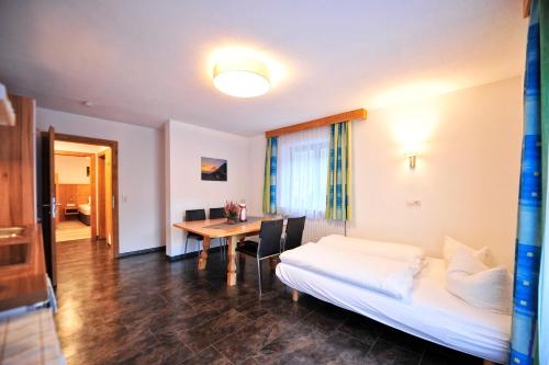 a hotel room with a bed and a table at Bäckerei Schranz in Sankt Leonhard im Pitztal