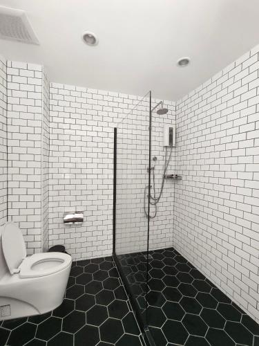 a bathroom with a toilet and a shower in it at Penthouse Lamoon in Bangkok