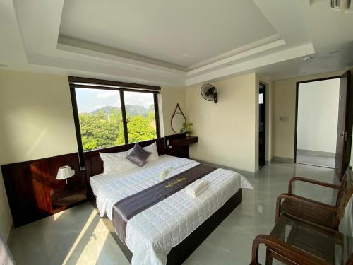 a bedroom with a bed and a large window at Center Tam Coc Homestay in Ninh Binh