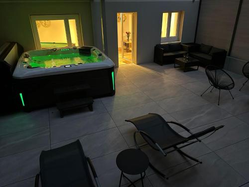 a living room with a pool table and chairs at Wohnung mit exklusivem Whirlpool und Sauna in Winterthur