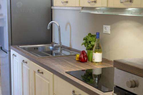 a kitchen with a sink and a bottle of wine at Masseria Comara in Monopoli