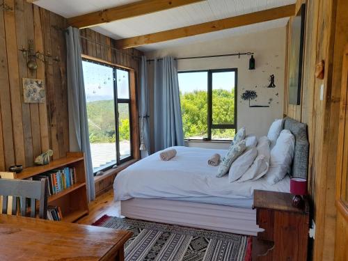 a bedroom with a bed and a large window at Butterfly House in The Crags