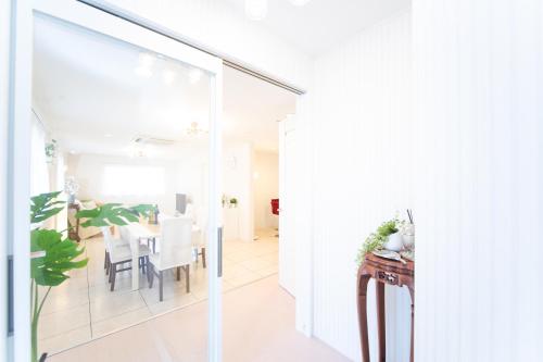 a dining room with a glass door leading to a dining table at Miraie Awaji Kuruma95 in Awaji