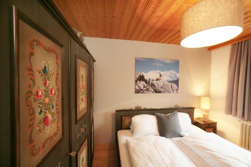 a bedroom with a bed with a wooden ceiling at Premium Chalet Andrea in Leogang