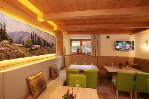 a restaurant with a large painting on the wall at Premium Chalet Andrea in Leogang