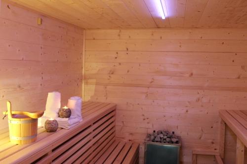 a wooden sauna with a bench with towels at Premium Chalet Andrea in Leogang