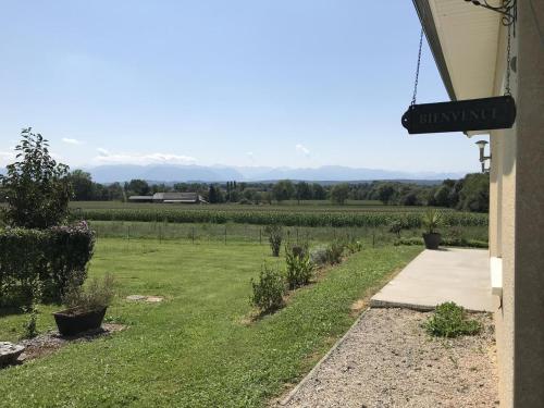 a view from the porch of a house with a field of vines at L'oree du bois in Livron