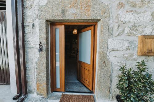 a wooden door leading into a building at La casa del Mayoral in Tremedal