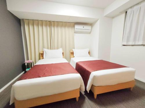 Ένα ή περισσότερα κρεβάτια σε δωμάτιο στο incense上野根岸601