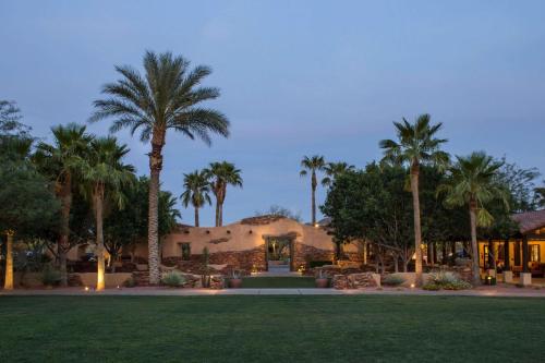 a resort with palm trees and a building at Bluegreen Vacations Cibola Vista Resort and Spa, an Ascend Collection Resort in Peoria