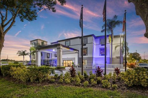 a building with two flags in front of it at Clarion Pointe Lakeland I-4 in Lakeland