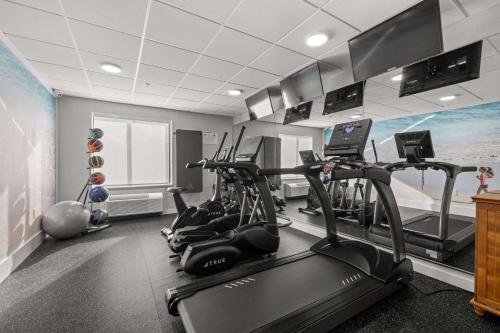 a gym with treadmills and exercise bikes in a room at Clarion Pointe Lakeland I-4 in Lakeland