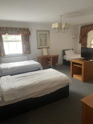 a hotel room with two beds and a television at Hotel 1843 Reading in Reading