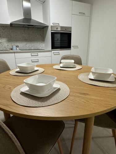 a wooden table with bowls and plates on it in a kitchen at City Residenz , Europa-Park - Rulantica in Lahr