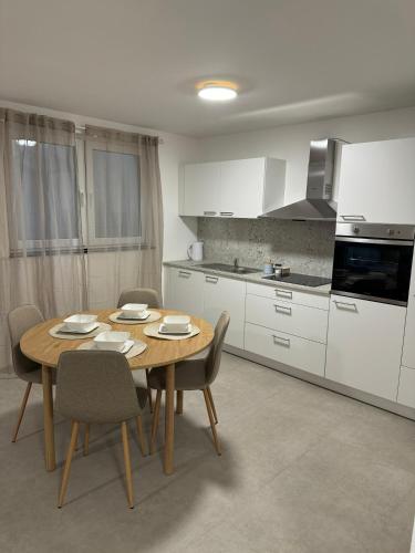 a kitchen with a wooden table and chairs in a kitchen at City Residenz , Europa-Park - Rulantica in Lahr