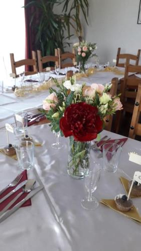 a table with a vase of flowers on it at wellness Chata u Pinkasů in Písečná