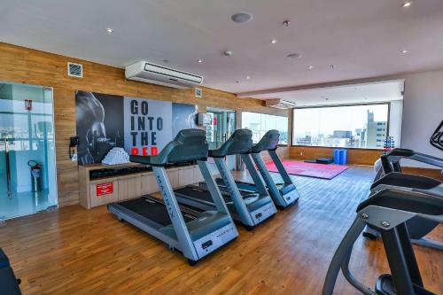 a gym with treadmills and ellipticals in a room at Radisson RED Campinas in Campinas