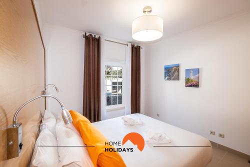 a bedroom with a bed with a lamp on it at #251 Coronel Águas by Home Holidays in Albufeira