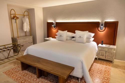 a bedroom with a large white bed with a wooden headboard at Hotel Casa Don Luis by Faranda Boutique, a member of Radisson Individuals in Cartagena de Indias