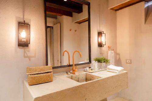 a bathroom with a sink and a large mirror at Hotel Casa Don Luis by Faranda Boutique, a member of Radisson Individuals in Cartagena de Indias