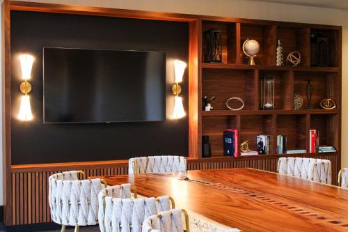 a conference room with a large wooden table and chairs at Radisson Blu Vancouver Airport Hotel & Marina in Richmond