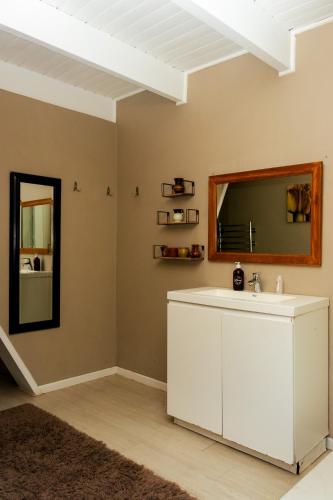 a bathroom with a sink and a mirror at STAY In TEHAMA in Cape Town