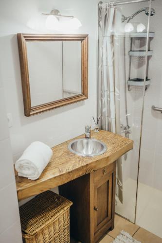 a bathroom with a sink and a shower at Casa da Carvalha in Vale de Cambra