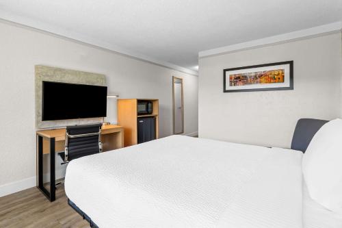 a hotel room with a bed and a flat screen tv at Quality Inn Slidell I-10 in Slidell