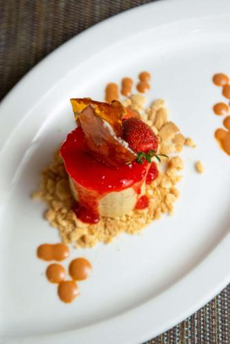 a white plate with a dessert with fruit and nuts at Hotel Faranda Guayacanes, a member of Radisson Individuals in Chitré