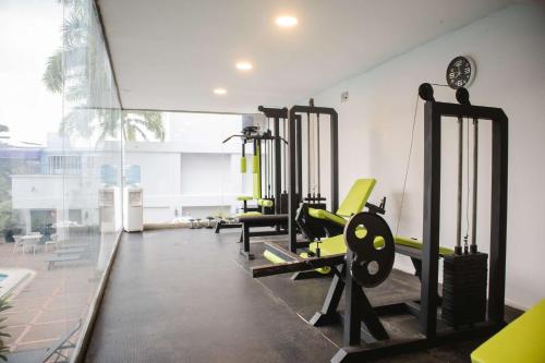a gym with treadmills and machines in a room at Hotel Faranda Express Puerta Del Sol Barranquilla, A Member of Radisson Individuals in Barranquilla