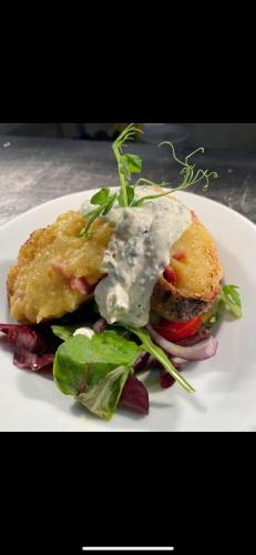 a plate of food with a sandwich and a salad at The Hind Hotel in Wellingborough