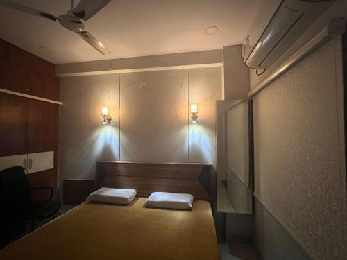 a room with two beds and two lights on the wall at Atlas Homes 1BHK HomeStays in Hyderabad
