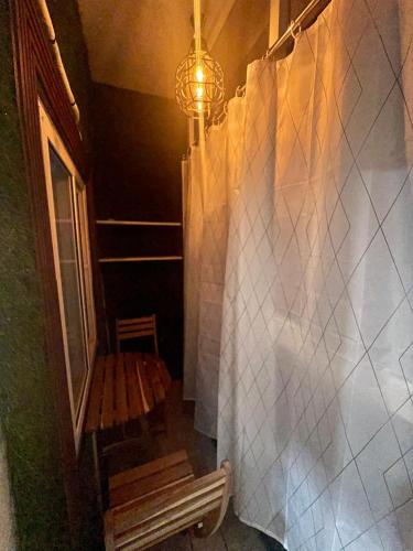 a bathroom with a shower with a bench and a chandelier at Atlas Homes 1BHK HomeStays in Hyderabad