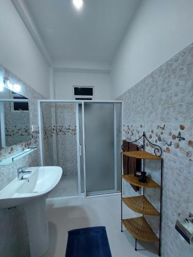 a bathroom with a white sink and a shower at Villa Olga in Unawatuna