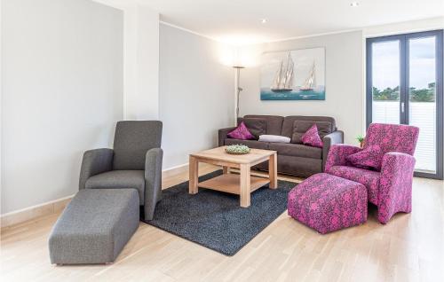 a living room with two chairs and a couch at Garden Suite in Binz