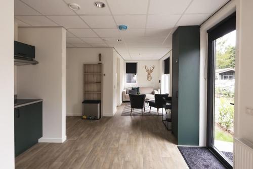 an empty room with a kitchen and a dining room at Tiny House 'Veluwehuisje' in Voorthuizen