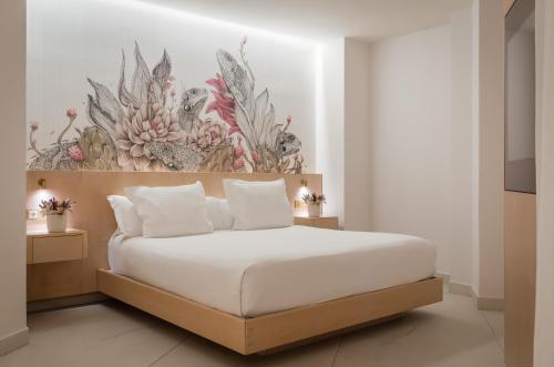 a bedroom with a bed with a flower mural on the wall at 45 Times Barcelona Hotel in Barcelona