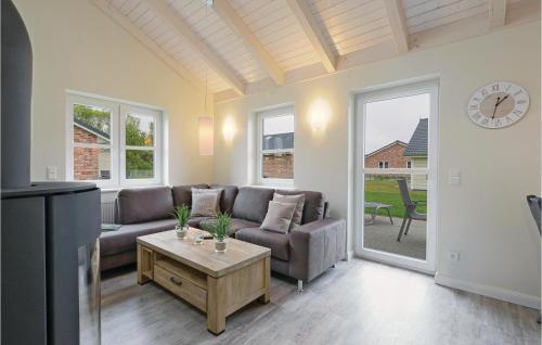 a living room with a couch and a table at Stunning Home In Dagebüll With Wifi in Dagebüll