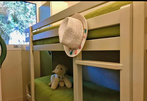 a teddy bear sitting on the bottom bunk of a bunk bed at U FARNIENTE in Bonifacio